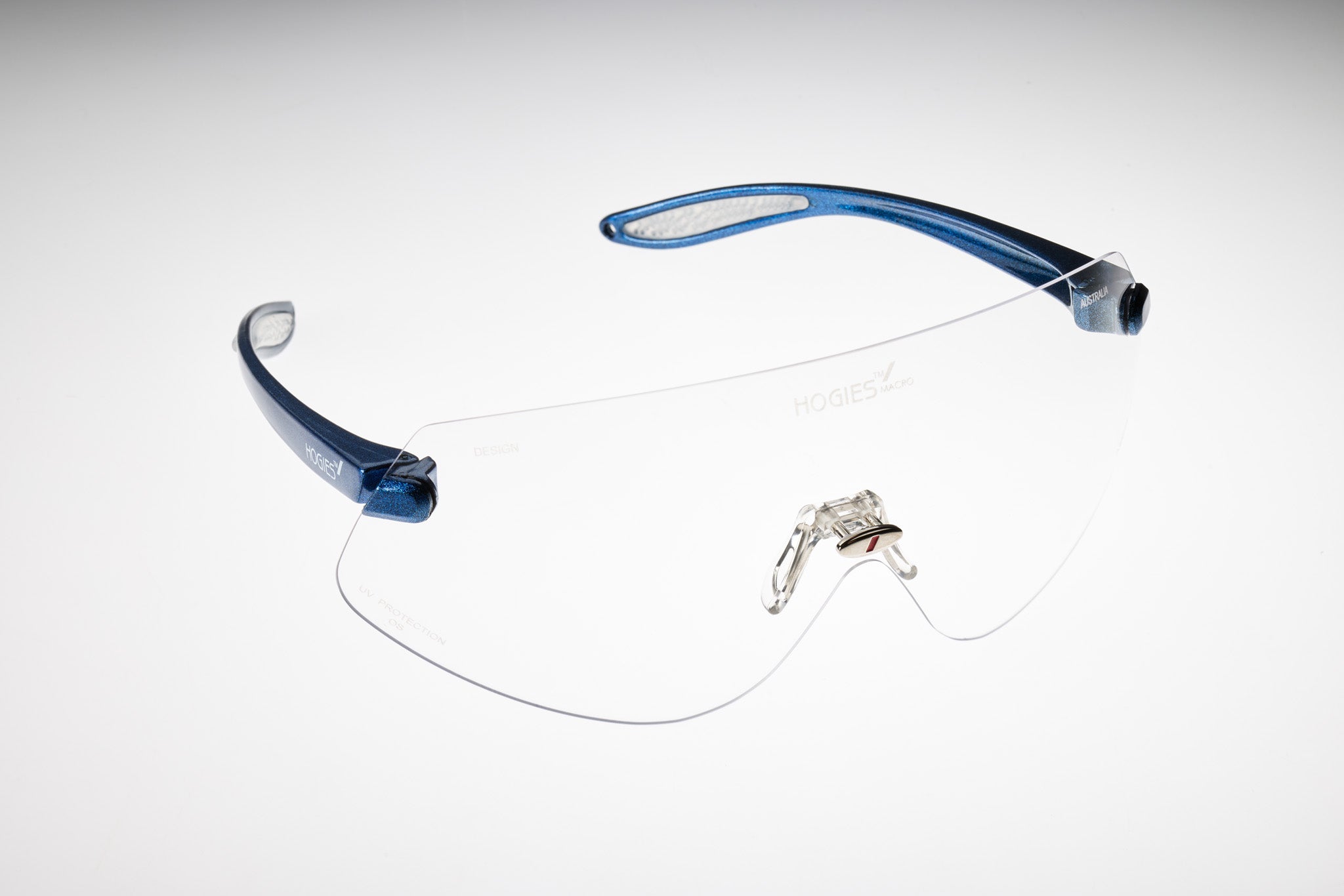 Clear safety glasses with a blue lanyard frame. The glasses are designed for large head shapes and meet low impact requirements of AS/NZS 1337.