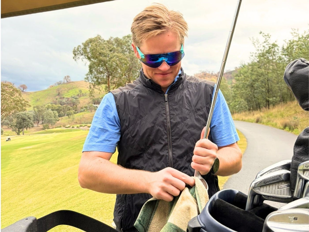 Golfer wearing tinted Hogies EyeGuard Sports glasses on the course